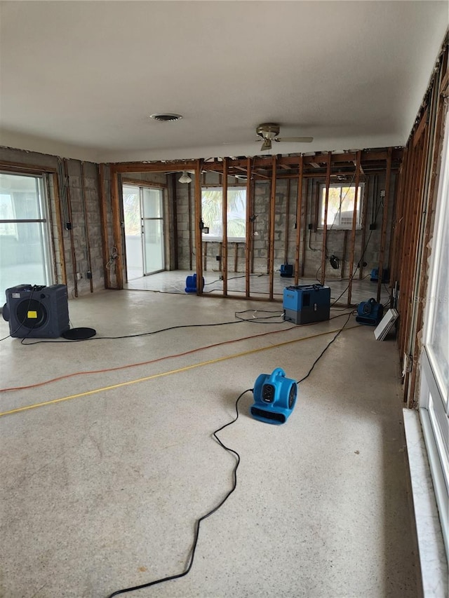 12520 4th St E, Treasure Island, FL 33706 - unfurnished living room with healthy amount of natural light and a ceiling fan