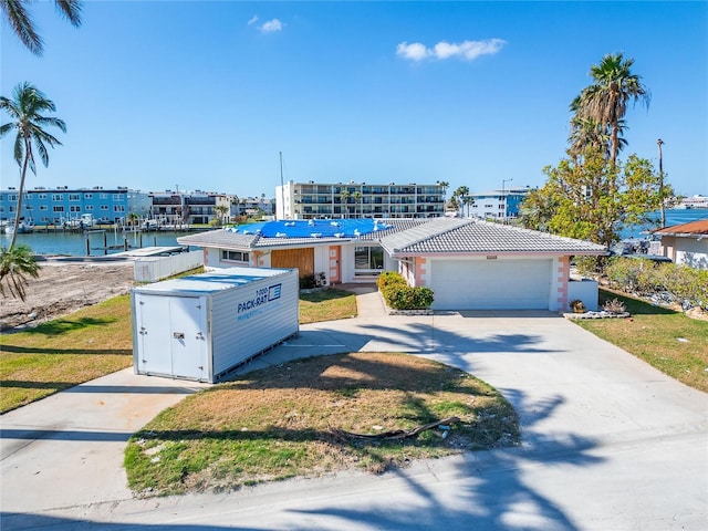 view of front facade featuring a garage and a water view