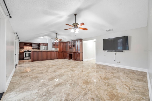 unfurnished living room featuring vaulted ceiling, ceiling fan, and a textured ceiling