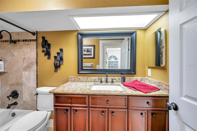 full bathroom featuring vanity, toilet, and tiled shower / bath