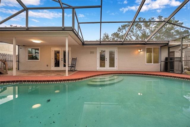 view of pool with a lanai, french doors, and a patio