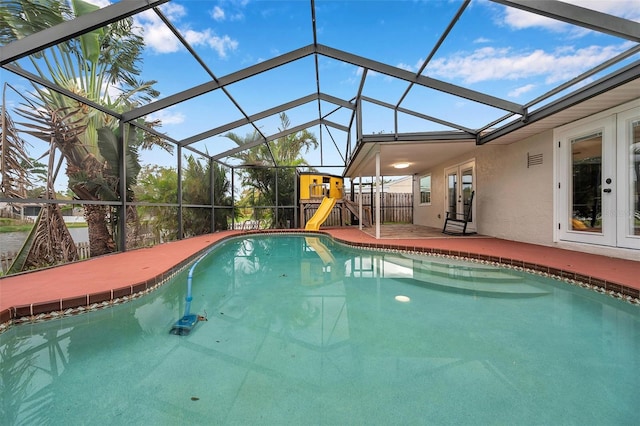 view of swimming pool with glass enclosure and a patio area