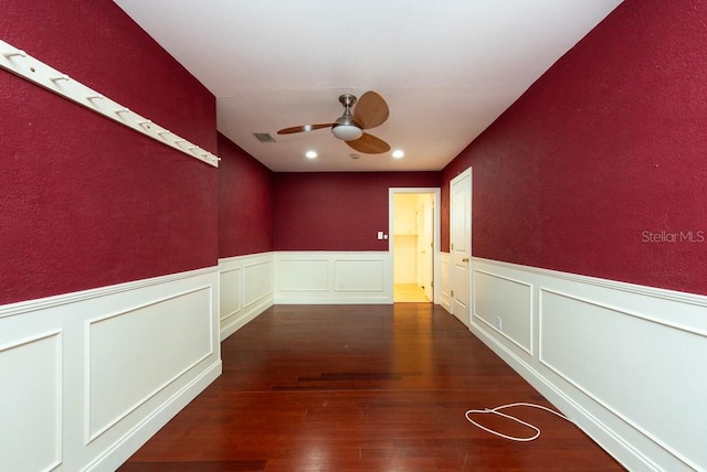 unfurnished room featuring dark wood-type flooring and ceiling fan