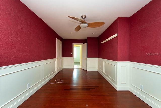 unfurnished room featuring dark hardwood / wood-style flooring and ceiling fan