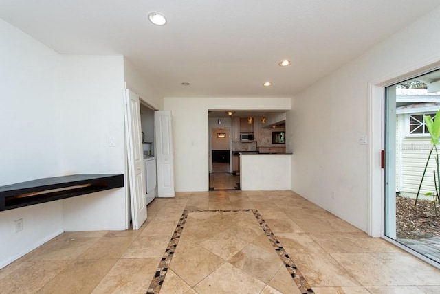 kitchen featuring washing machine and clothes dryer and plenty of natural light