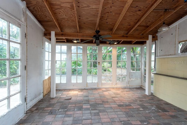 unfurnished sunroom with ceiling fan and a healthy amount of sunlight