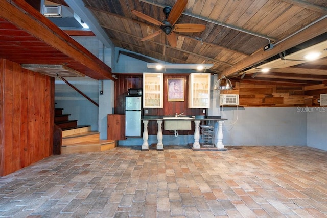 basement featuring ceiling fan, wood ceiling, white fridge, and sink