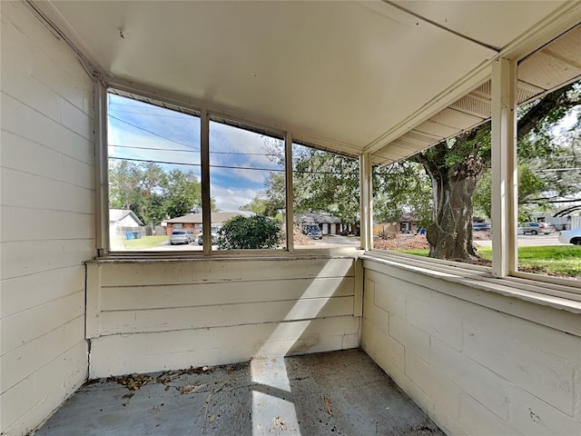 unfurnished sunroom featuring vaulted ceiling