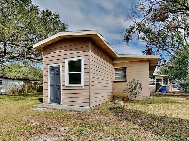 view of outbuilding with a lawn