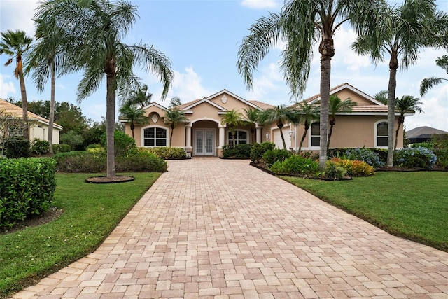 view of front of home with french doors and a front yard