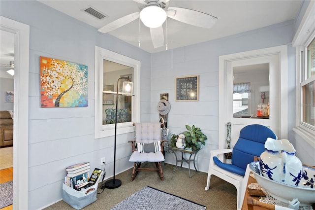 sitting room with carpet floors and ceiling fan