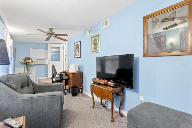 carpeted living room with ceiling fan and built in shelves