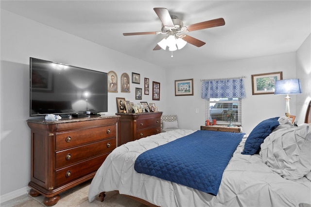 tiled bedroom featuring ceiling fan