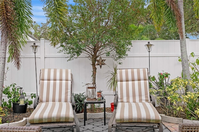 view of patio featuring fence