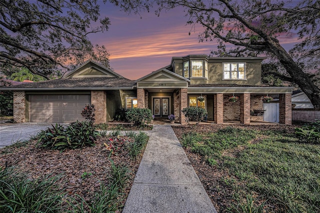 view of front facade featuring french doors and a garage