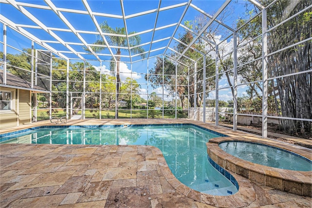 view of swimming pool with glass enclosure, an in ground hot tub, and a patio