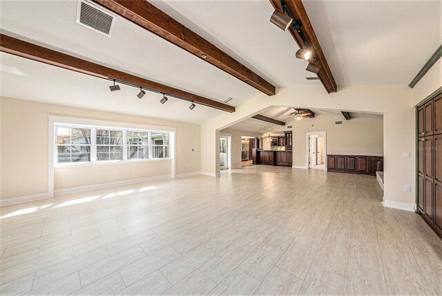 unfurnished living room with ceiling fan, light hardwood / wood-style flooring, lofted ceiling with beams, and track lighting