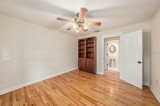 unfurnished bedroom featuring ceiling fan, light wood-type flooring, and sink