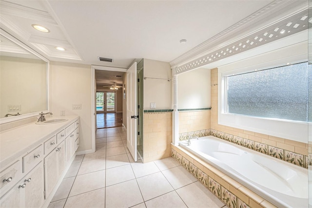 bathroom featuring ornamental molding, vanity, ceiling fan, tile patterned flooring, and tiled bath