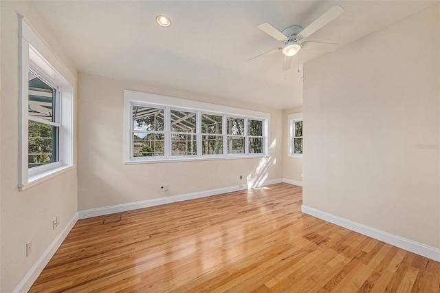 unfurnished room with ceiling fan, light hardwood / wood-style flooring, and a healthy amount of sunlight