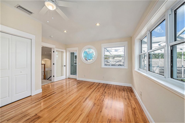 unfurnished bedroom featuring ceiling fan, a closet, and light wood-type flooring