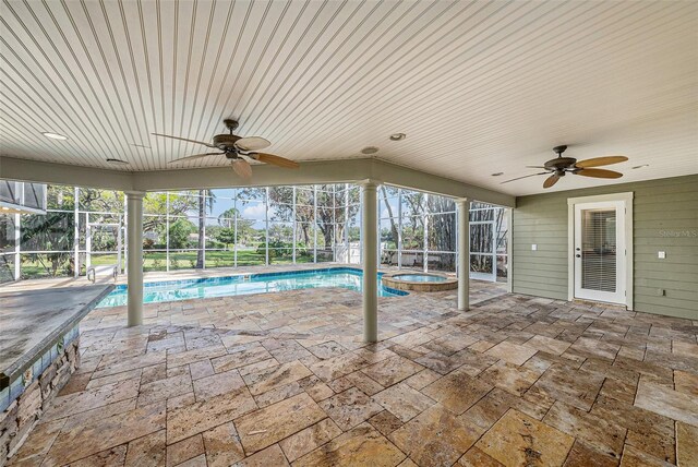 view of swimming pool with a lanai, ceiling fan, a patio area, and an indoor in ground hot tub