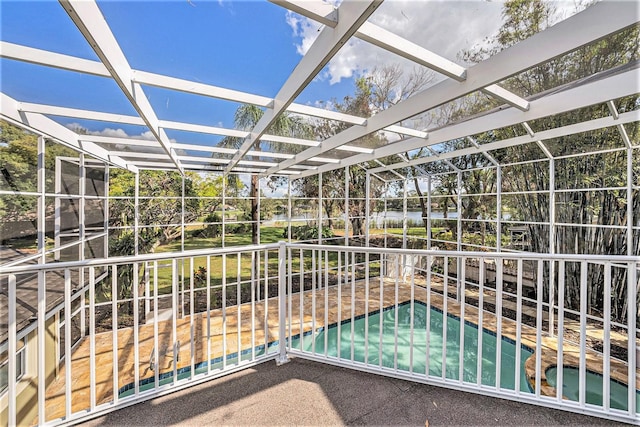 view of swimming pool featuring a lanai and a patio