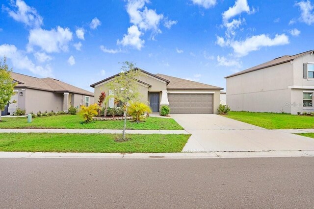 view of front of property with a garage and a front lawn