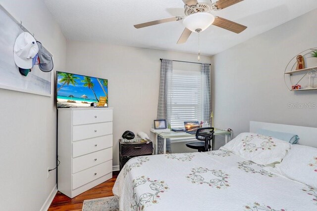 bedroom with hardwood / wood-style floors and ceiling fan