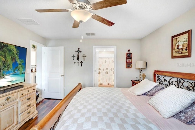 bedroom featuring dark wood-type flooring, ceiling fan, and ensuite bathroom