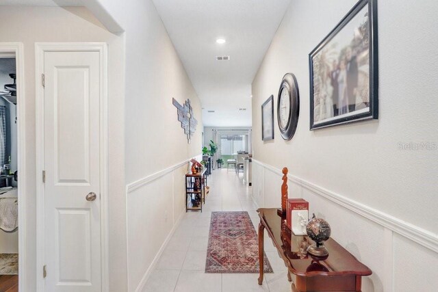 hall with light tile patterned floors