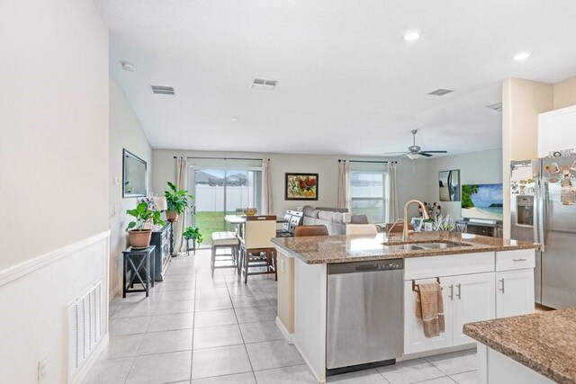 kitchen featuring white cabinetry, sink, a healthy amount of sunlight, and appliances with stainless steel finishes