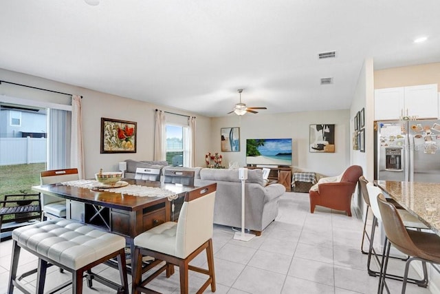 tiled dining space featuring ceiling fan