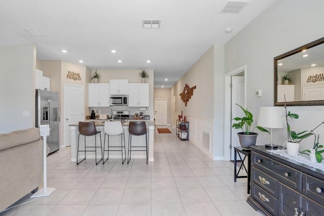 9407 Channing Hill Dr, Ruskin, FL 33573 - kitchen with white cabinets, visible vents, a sink, and appliances with stainless steel finishes
