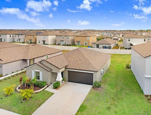 9407 Channing Hill Dr, Ruskin, FL 33573 - view of front of home featuring a residential view, stucco siding, an attached garage, driveway, and a front yard