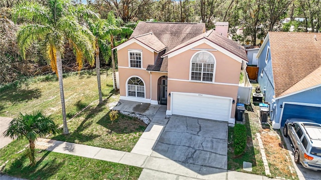 view of front property with a front lawn and a garage