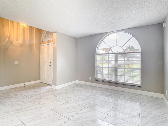 spare room featuring a textured ceiling