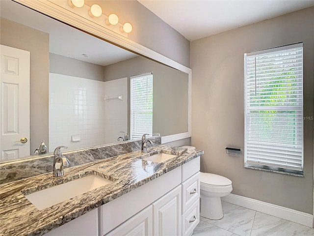 bathroom featuring vanity, toilet, and a tile shower