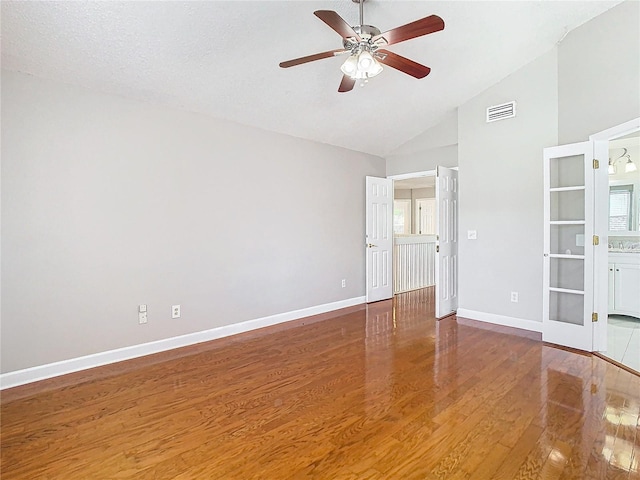 unfurnished room featuring high vaulted ceiling, hardwood / wood-style floors, ceiling fan, and a textured ceiling