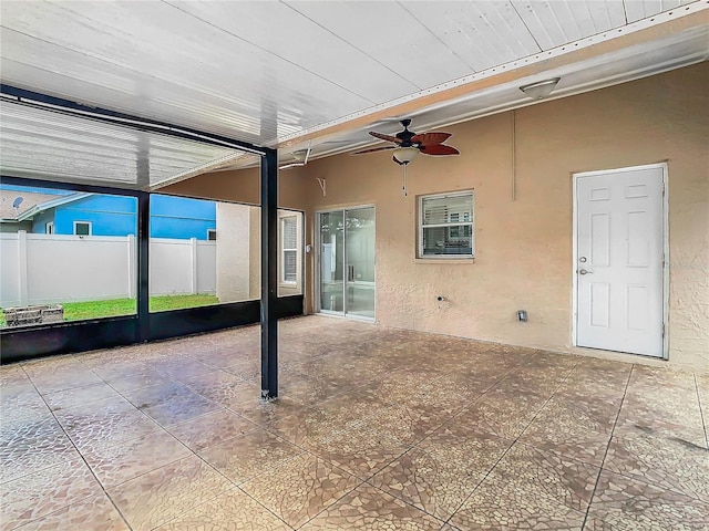 unfurnished sunroom with ceiling fan and wood ceiling