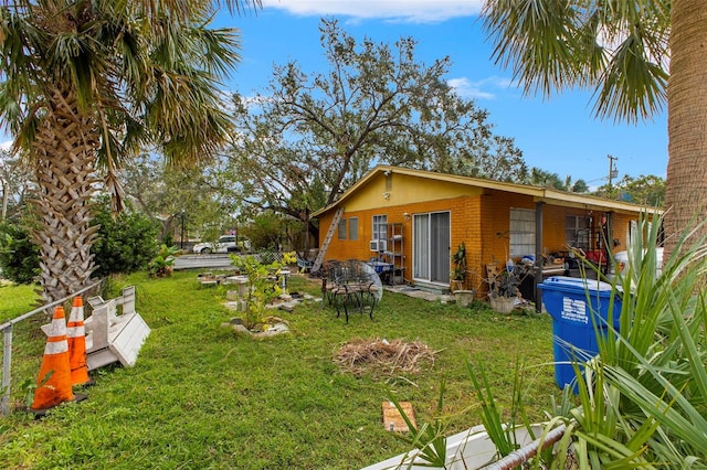 back of house featuring a yard