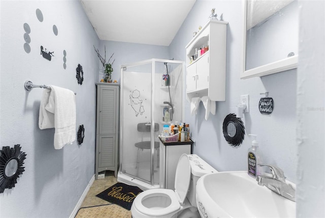 bathroom with toilet, an enclosed shower, and sink