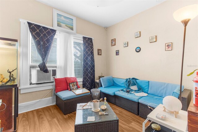 living room with cooling unit and light wood-type flooring