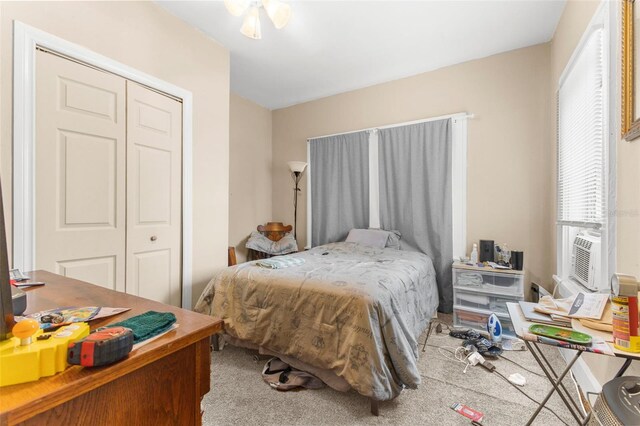 bedroom with ceiling fan, carpet flooring, a closet, and cooling unit