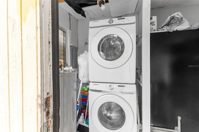 clothes washing area featuring stacked washer and clothes dryer