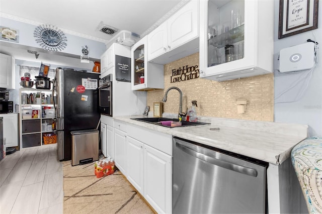 kitchen with stainless steel appliances, white cabinets, sink, ornamental molding, and backsplash