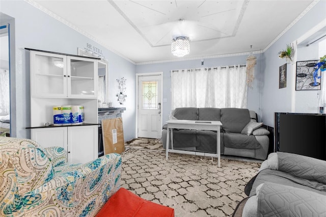 living room featuring ornamental molding, carpet flooring, and a notable chandelier