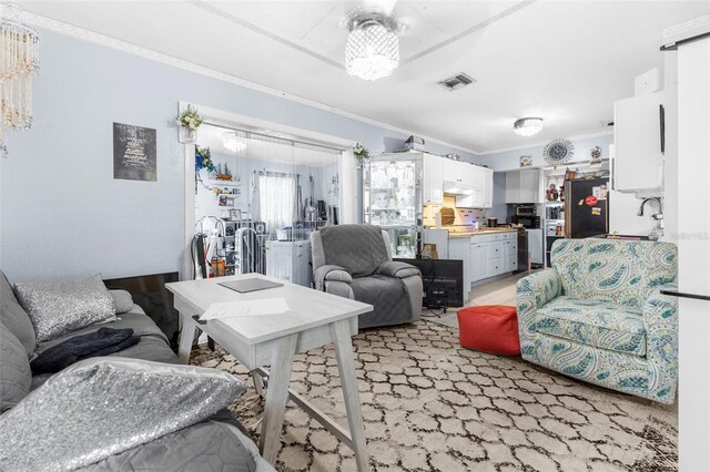 living room with light carpet and crown molding