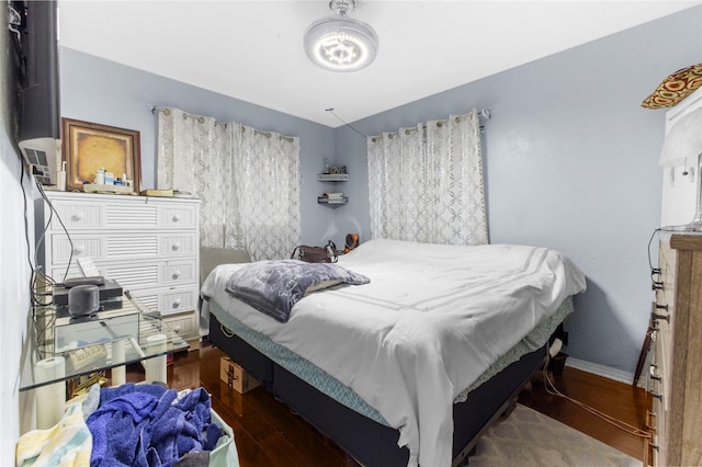 bedroom with dark hardwood / wood-style floors