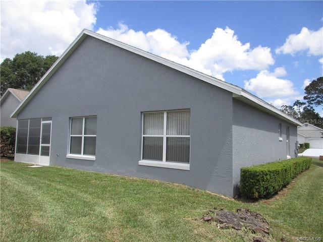 view of side of home with a lawn